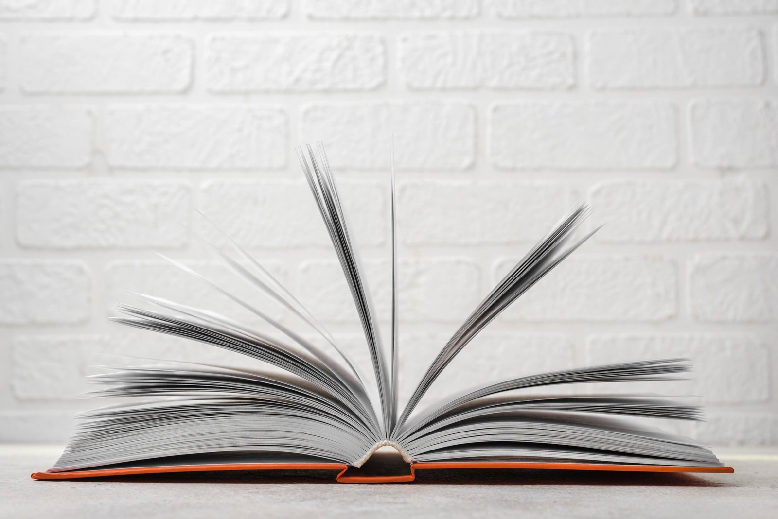 front-view-open-hardback-book-desk